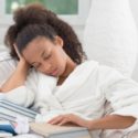 Black Woman Falling Asleep with a Book