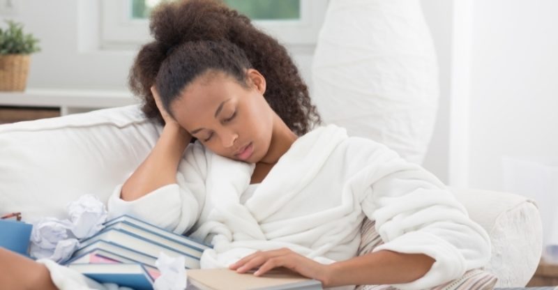 Black Woman Falling Asleep with a Book